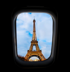Skyscape through aeroplane window during flight in wing with blue sky. View of Eiffel tower in Paris ,  antique iron tower in Europe , romantic attraction for honeymoon couple and traveler