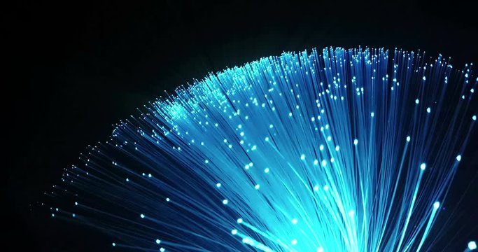 detail of multi color from blue growing bunch with fade effect of optical fibers on black background, space for text, fast light signal for high speed internet connection