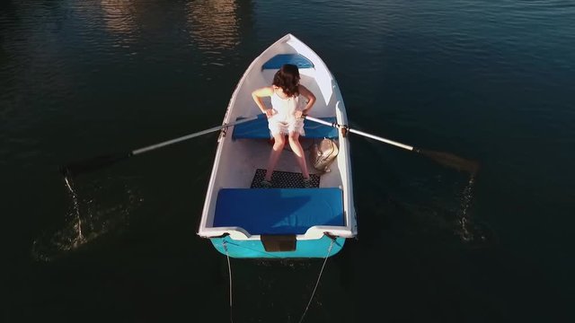 Young girl boating on the lake