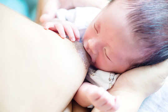 Baby sucking from mother's breast. Breastfeeding concept. breastfeeding and infant. baby healthy and hospitality. image for background, wallpaper, copy space, illustration,article and advertisement.