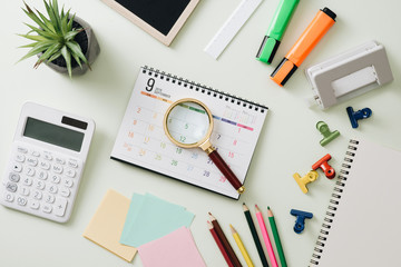 Business concept: stapler,markers, magnifier, cutter, tape, pen, pencil, clip, calculator, calendar and color pencil