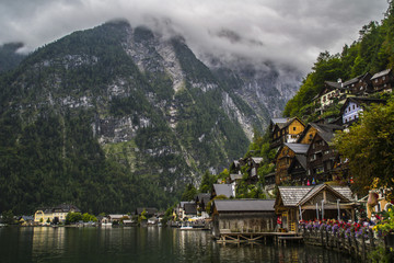 Traditional european alpine houses in Austria, Hallstatt on foggy moody summer day. UNESCO world heritage destination in Europe. Tourist popular attraction on shore of Hallstätter See,  Salzkammergut 