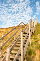 wooden steps heading up to hill on seaside beach and sand dunes at Lowestoft Suffolk