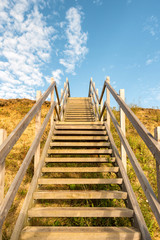 wooden steps heading up to hill on seaside beach and sand dunes at Lowestoft Suffolk