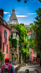 Man walks into a narrow street in Montmartre, Paris,