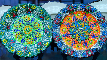 Beautiful colorful plate with traditional Turkish flower ornate, painting on the dishes. Souvenir shop.