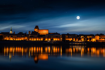 Old town reflected in river at sunset. Torun, Poland © proslgn