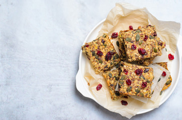 Granola Bars, Superfood Homemade Snack, Healthy Bars with Cranberry, Pumpkin Seed, Oats, Chia and Flax Seed on bright background