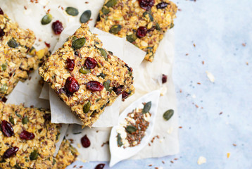 Granola Bars, Superfood Homemade Snack, Healthy Bars with Cranberry, Pumpkin Seed, Oats, Chia and Flax Seed on bright background