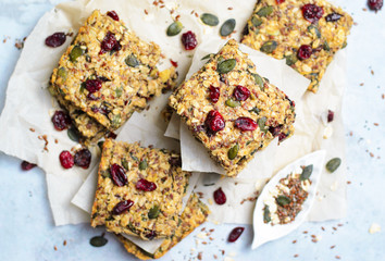 Granola Bars, Superfood Homemade Snack, Healthy Bars with Cranberry, Pumpkin Seed, Oats, Chia and Flax Seed on bright background