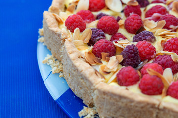 on a blue table there is a fresh berry pie