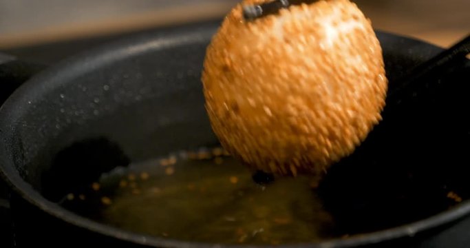 Glutinous rice balls covered with sesame seeds deep fried at medium oil temperature, 4K