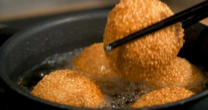 Glutinous rice balls covered with sesame seeds deep fried at medium oil temperature, 4K