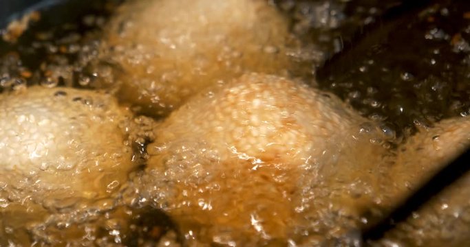 Glutinous rice balls covered with sesame seeds deep fried at medium oil temperature, 4K