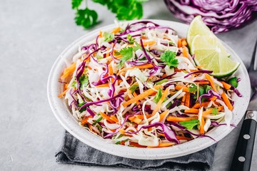 Cilantro lime coleslaw salad with red and white cabbage on stone background - obrazy, fototapety, plakaty