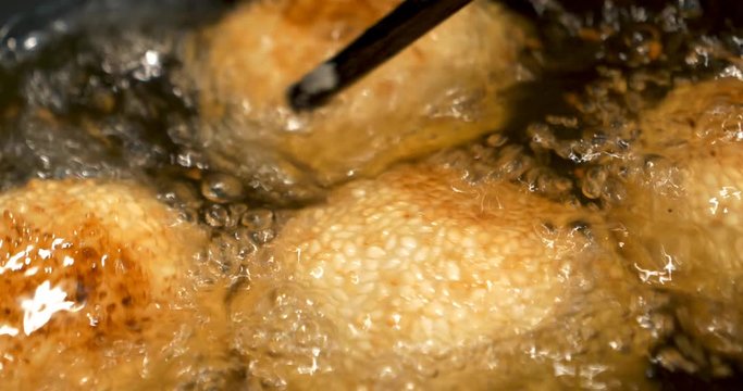 Glutinous rice balls covered with sesame seeds deep fried at medium oil temperature, 4K