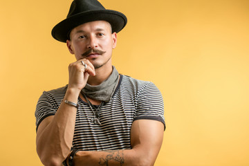 Confident professional shoemaker wearing moustache in trendy hat