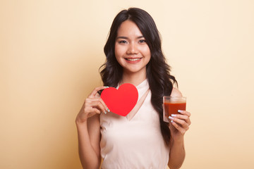 Young Asian woman with tomato juice and red heart.