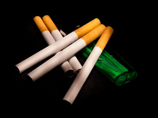 Cigarettes and lighter on a dark black background