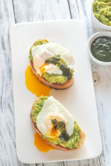 Sandwiches with guacamole and poached eggs