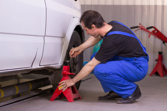 Mechanic Uses Jackscrew