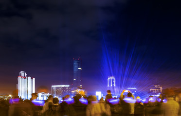 crowds of people watching laser show at celebration in the city center on the waterfront, Yekaterinburg