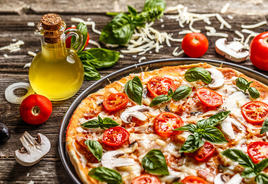 Fresh pizza with tomatoes, cheese and mushrooms
