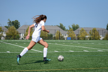 Girl sprinting towards the goal by herself