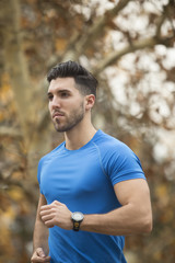 Athletic young man running in the nature. Healthy lifestyle