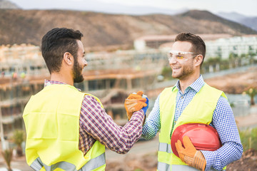 Builders on residential construction site making a deal