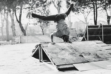 Afro guys with dreadlocks breakdancing in city skate park outdoor - Young breakdancer performing...