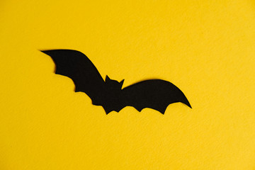 Paper bat on yellow background. Halloween concept