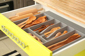 Obraz na płótnie Canvas Wooden kitchen utensils in drawer indoors