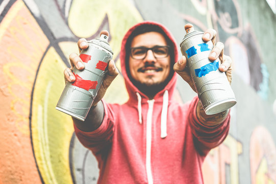 Young happy man drawing with two smiling sprays
