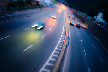 Night car traffic. Motion blur car viewed from the road bridge in big modern city.