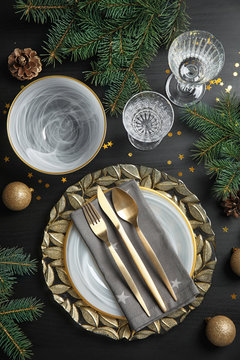 Elegant table setting on dark background, top view. Christmas celebration