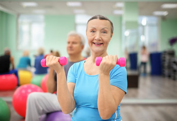 Mature woman training in modern gym