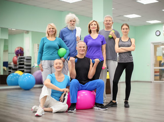 Group of elderly people with trainer in gym