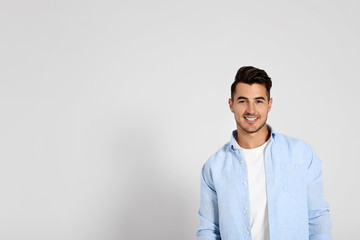 Portrait of handsome young man and space for text on white background