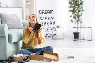 Young woman unpacking parcel at home