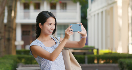 Woman use of cellphone for take photo at outdoor