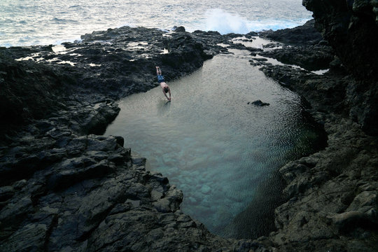 man jumps into tide pool