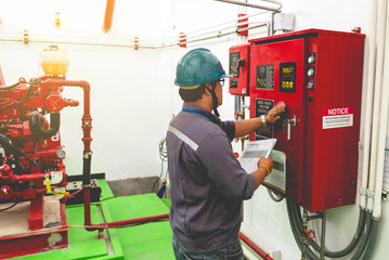 Engineer checking industrial generator fire control system