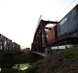 Sunset on the railway bridge. Evening