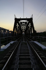 Sunset on the railway bridge. Evening