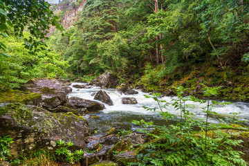 Glaslyn river running through Beddgelert valley in the heart of Smowdonia National Park in Gwynedd, Wales, UK