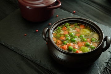 Fresh vegetable soup in a ceramic pot.