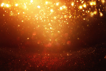 glitter vintage lights background. black and gold. de-focused.