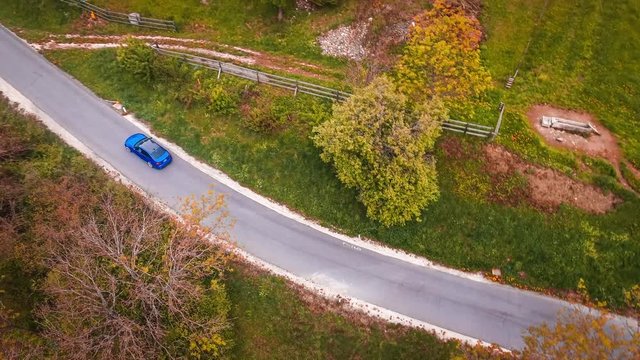 Tracking shot of a car drifting on a mountain road