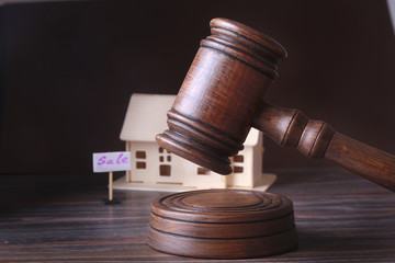 House for sale, auction hammer , symbol of authority and Miniature house . Courtroom concept.